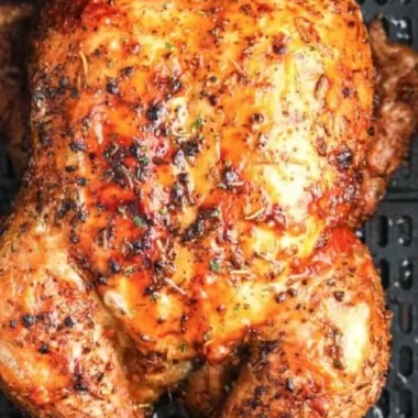 Air Fryer whole roasted chicken garnished and ready to serve