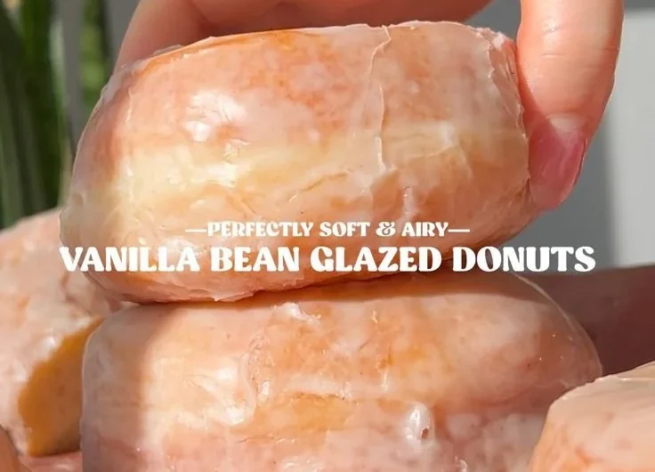 Delicious homemade glazed donuts with a shiny icing on a plate