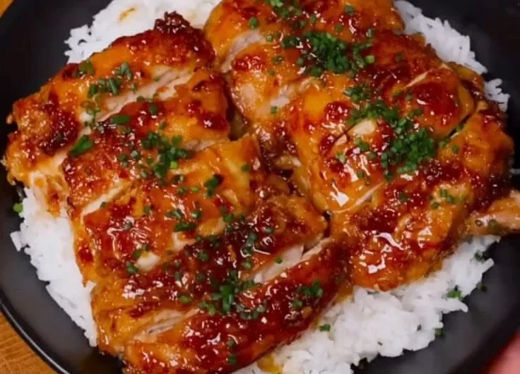 Delicious Honey Lemon Garlic Chicken garnished with fresh herbs.