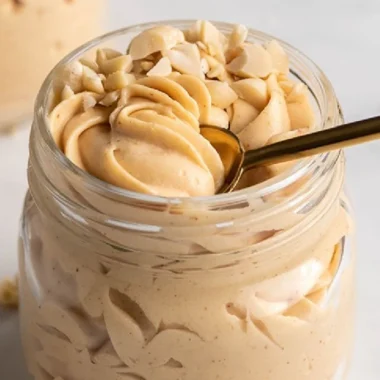Keto Peanut Butter Mousse dessert in a bowl topped with crushed peanuts