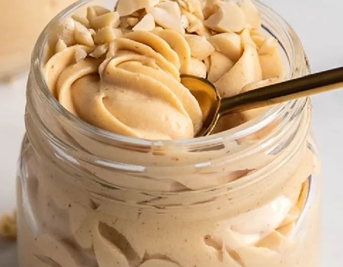 Keto Peanut Butter Mousse dessert in a bowl topped with crushed peanuts