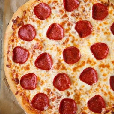 Delicious slice of pepperoni pizza topped with melted cheese and spices
