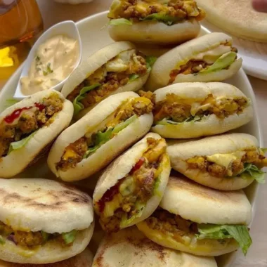 Freshly baked Plof Bread Rolls served on a wooden platter