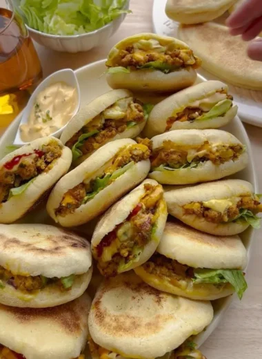 Freshly baked Plof Bread Rolls served on a wooden platter