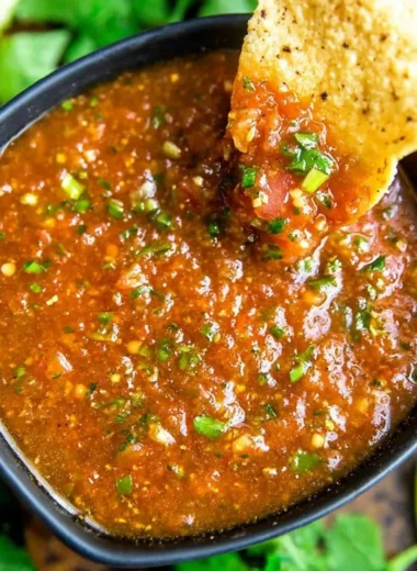 Freshly blended salsa made in a blender, featuring vibrant tomatoes and herbs.