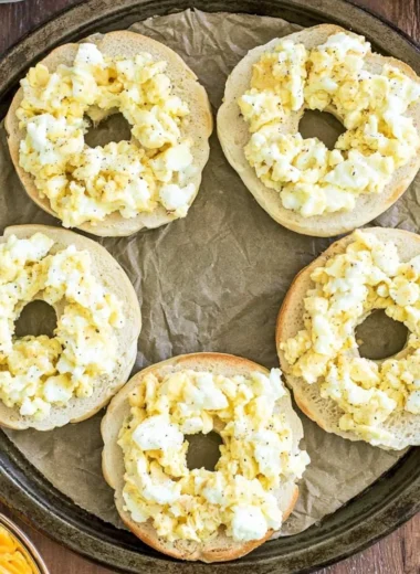 Delicious Breakfast Pizza Bagels topped with cheese, eggs, and veggies