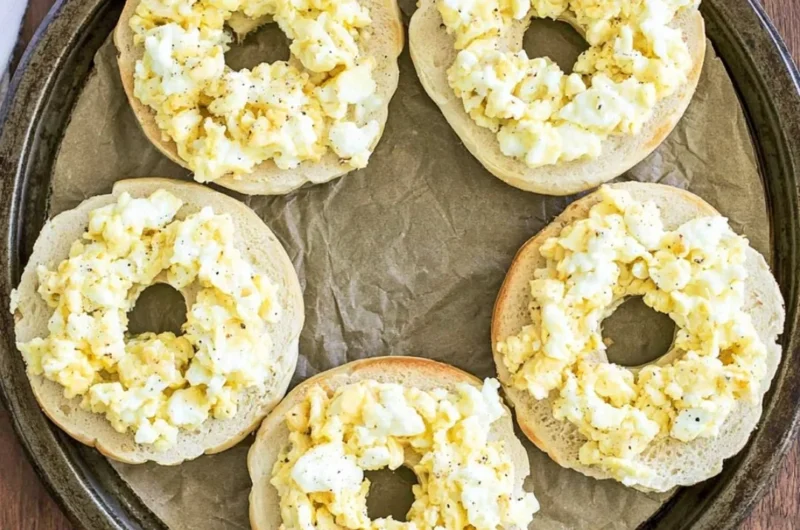 Delicious Breakfast Pizza Bagels topped with cheese, eggs, and veggies