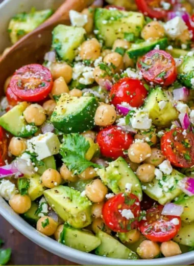 Colorful chickpea salad with fresh vegetables and herbs in a bowl