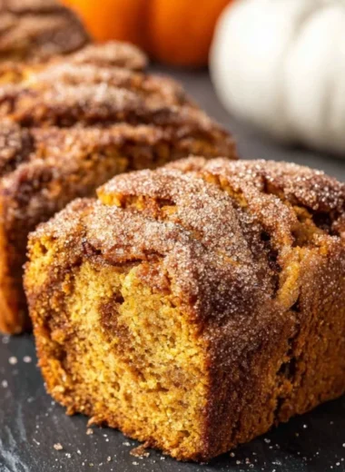 Cinnamon Swirl Pumpkin Bread Minis, freshly baked and garnished with cinnamon swirl