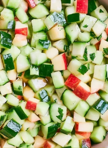 A vibrant cucumber apple salad served in a bowl with fresh ingredients