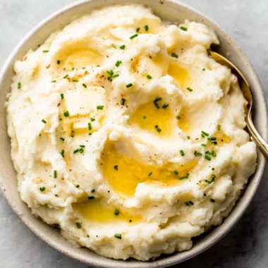 Bowl of easy garlic mashed potatoes with butter and herbs