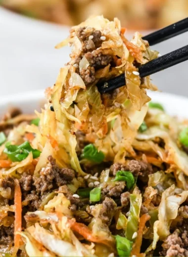 Bowl of egg roll ingredients with vibrant vegetables and protein, ready to serve.