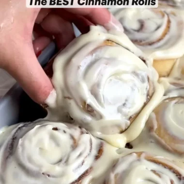 Freshly baked homemade cinnamon rolls topped with creamy icing