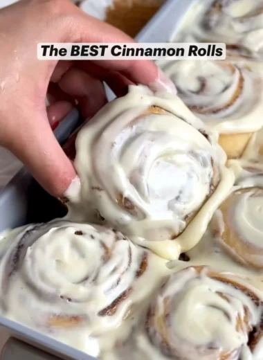 Freshly baked homemade cinnamon rolls topped with creamy icing
