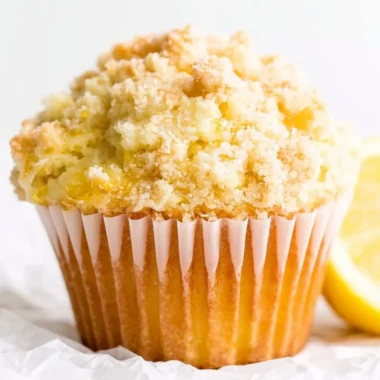 Freshly baked lemon muffins with a golden crust and zesty lemon glaze.
