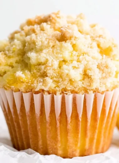 Freshly baked lemon muffins with a golden crust and zesty lemon glaze.