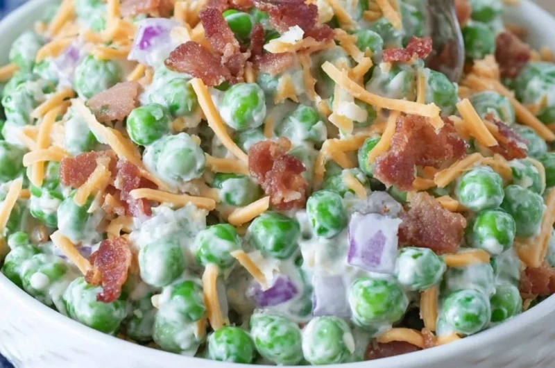Bowl of old fashioned pea salad with bacon, onions, and creamy dressing