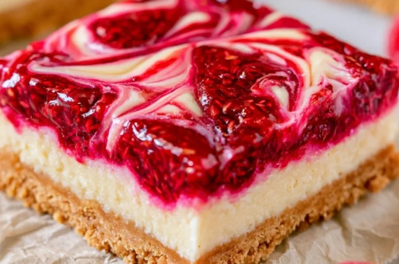 Delicious Raspberry Cheesecake Bars topped with fresh raspberries