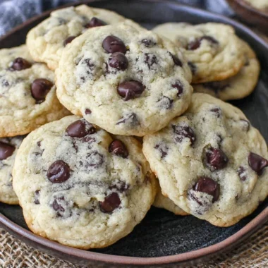 Freshly baked yogurt chocolate chip cookies on a cooling rack.
