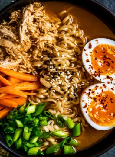 Delicious bowl of chicken ramen garnished with green onions and soft-boiled egg