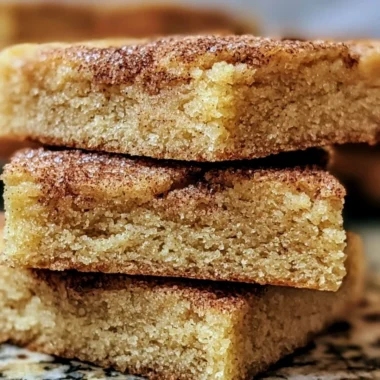 Chewy snickerdoodle cookie bars topped with cinnamon and sugar