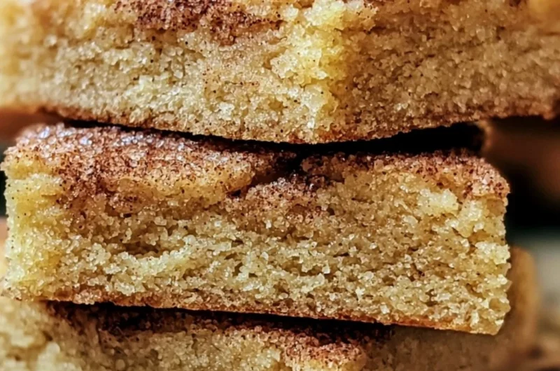 Chewy snickerdoodle cookie bars topped with cinnamon and sugar