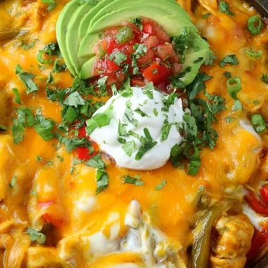 Cheesy chicken fajitas casserole served in a dish with colorful peppers and cheese