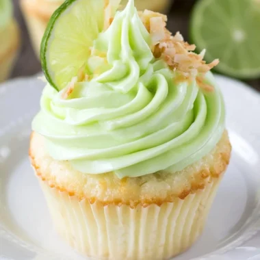 Coconut cupcakes topped with lime frosting, a delicious tropical dessert.