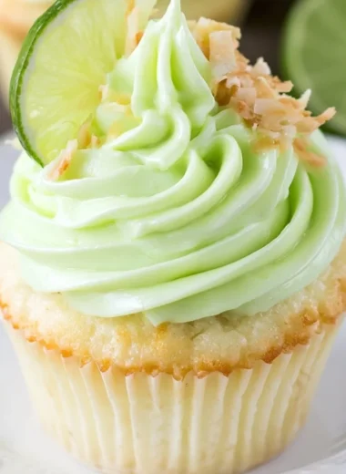 Coconut cupcakes topped with lime frosting, a delicious tropical dessert.