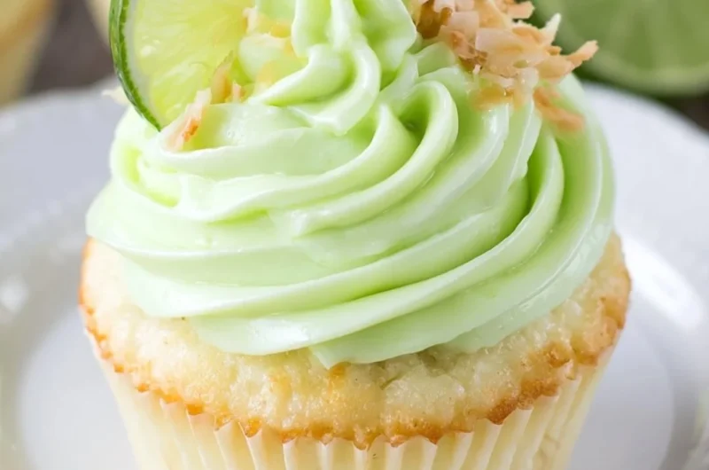Coconut cupcakes topped with lime frosting, a delicious tropical dessert.