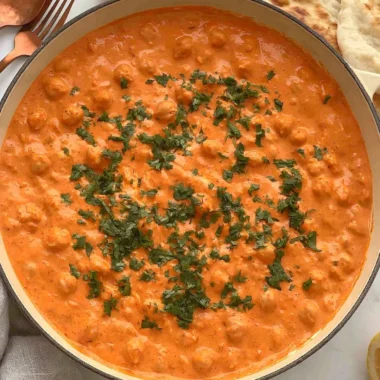 Cozy Indian butter chickpeas served in a bowl with herbs and spices