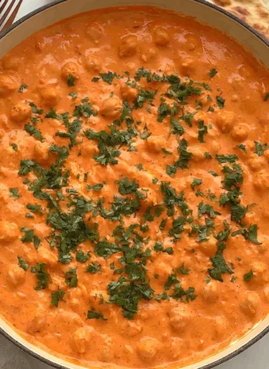 Cozy Indian butter chickpeas served in a bowl with herbs and spices