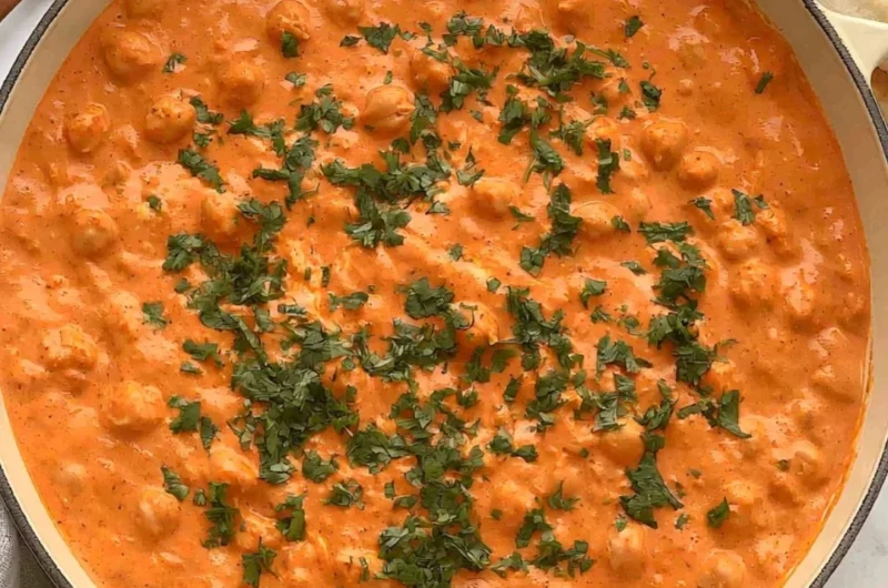 Cozy Indian butter chickpeas served in a bowl with herbs and spices