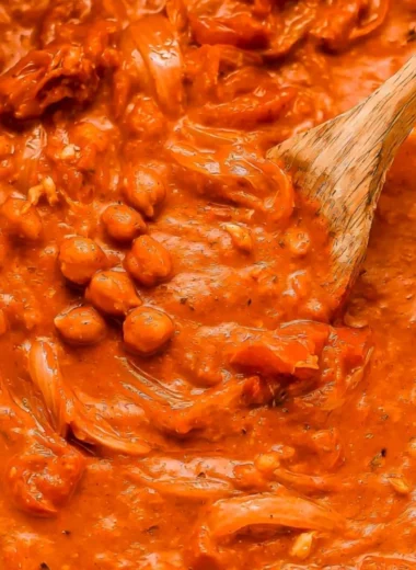 Creamy coconut chickpea curry served in a bowl with herbs.