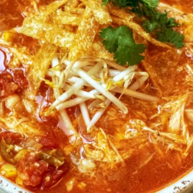 Bowl of delicious Crock Pot Chicken Tortilla Soup garnished with tortilla strips.