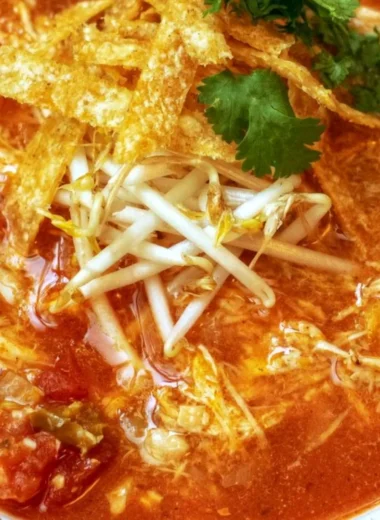 Bowl of delicious Crock Pot Chicken Tortilla Soup garnished with tortilla strips.