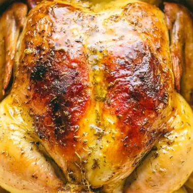 Juicy Dutch Oven whole chicken served with herbs and vegetables.