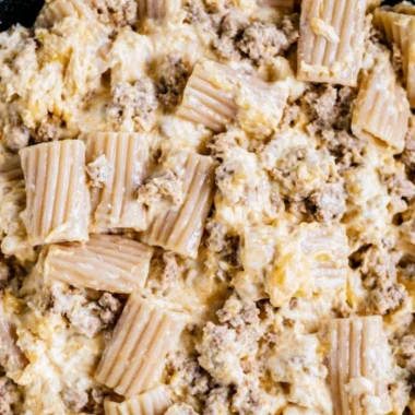 Delicious homemade cheeseburger pasta served in a bowl with cheese and herbs.