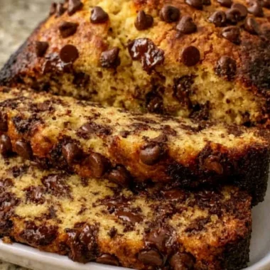 Super moist chocolate chip banana bread slice on a plate