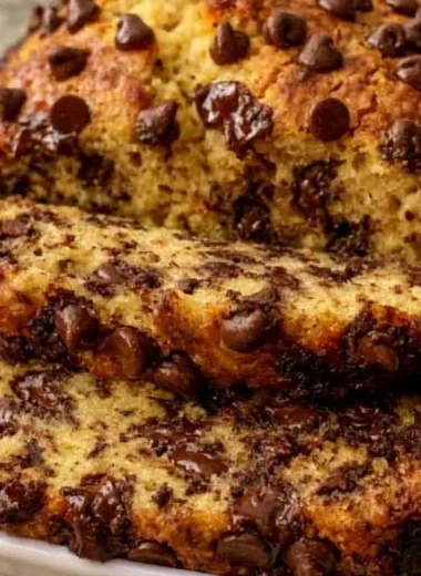 Super moist chocolate chip banana bread slice on a plate