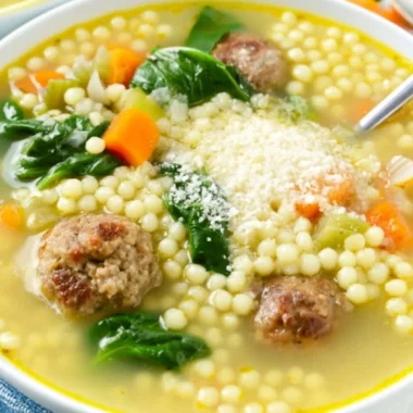 Bowl of Italian Wedding Soup with meatballs and greens