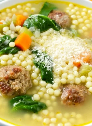 Bowl of Italian Wedding Soup with meatballs and greens