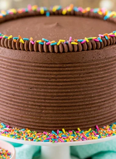 Moist yellow cake with chocolate frosting on a plate