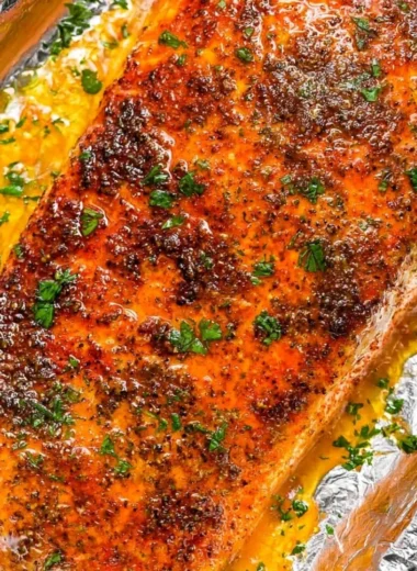 Delicious oven baked salmon with herbs and lemon on a plate