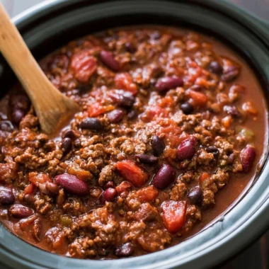 A bowl of delicious slow cooker chili with beans and spices.