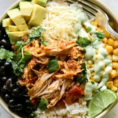 Cozy chicken burrito bowl filled with rice, beans, and fresh toppings