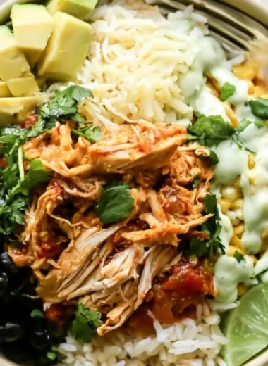 Cozy chicken burrito bowl filled with rice, beans, and fresh toppings