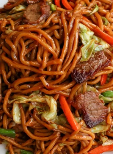Delicious cozy beef lo mein dish garnished with vegetables
