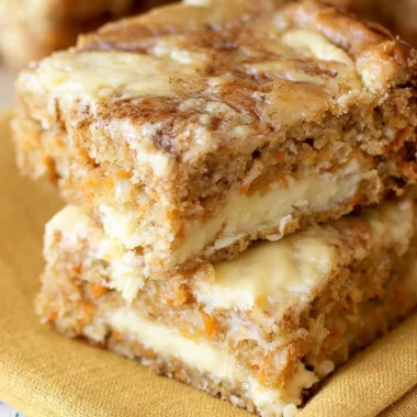 Delicious cozy carrot cake bars topped with cream cheese frosting and nuts