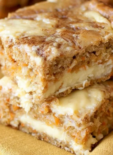 Delicious cozy carrot cake bars topped with cream cheese frosting and nuts